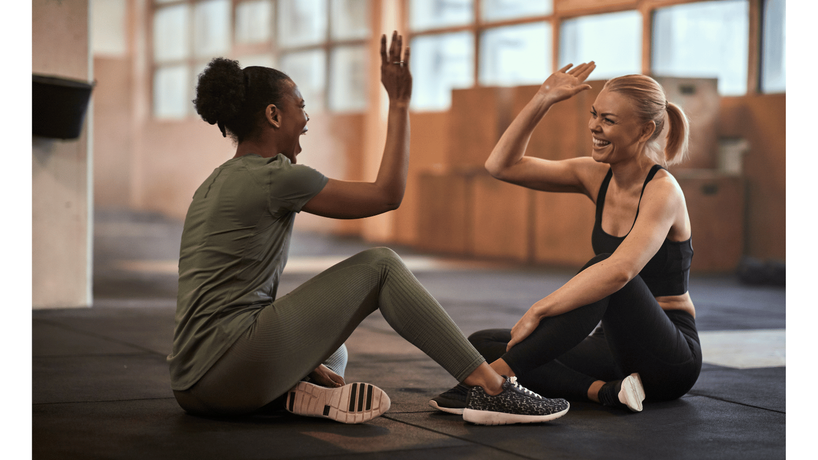 Diverse women over 40 celebrating their fitness achievements in a supportive wellness community